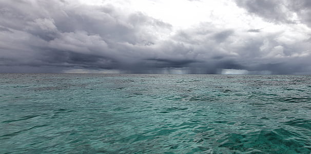 calm ocean under cloudy sky thumbnail