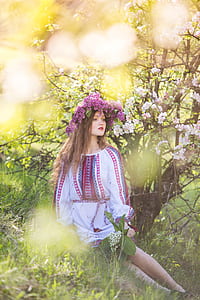 woman in white and pink dress wearing purple floral hair ornament thumbnail