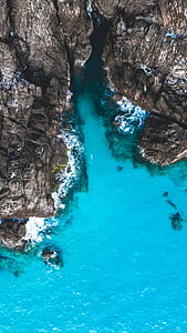 aerial view of mountain and body of water thumbnail