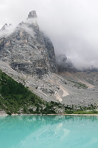 gray and brown rock formation under cloudy sky thumbnail