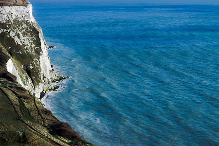 mountain cliff and body of water thumbnail