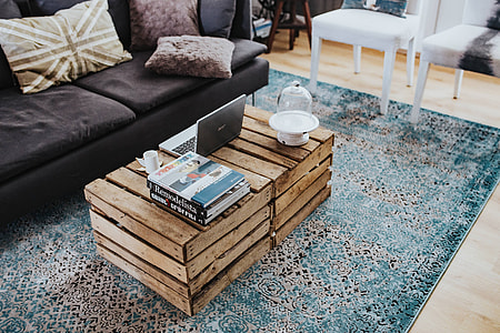 Designer living room interior with a wooden box table and a light blue carpet thumbnail
