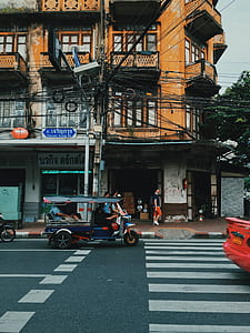 blue and black auto rickshaw on the road during daytime thumbnail