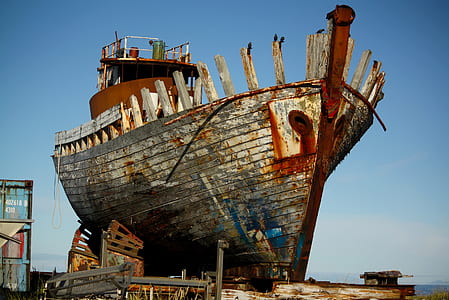 brown and red boat beside intermodal container thumbnail