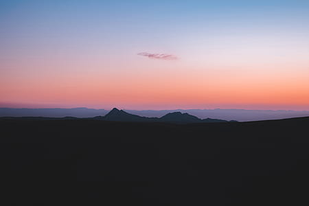 silhouette photography of mountain during golden hour thumbnail