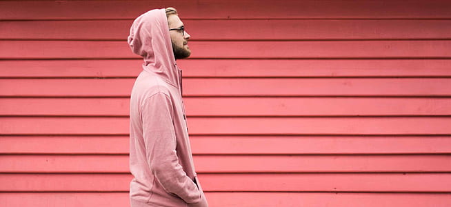 man standing beside wall thumbnail