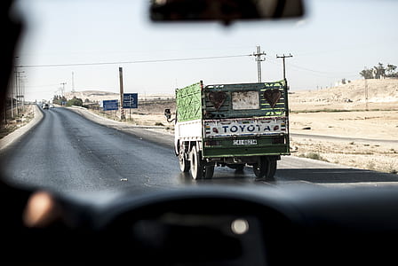 white and green Toyota vehicle on asphalt road thumbnail
