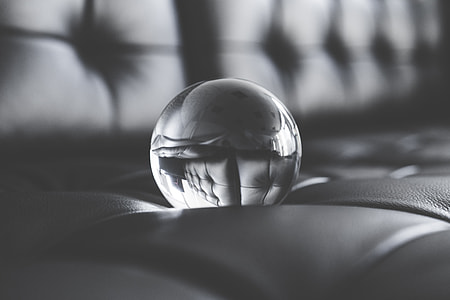 Big Glass Crystal Ball on Black Leather Sofa thumbnail