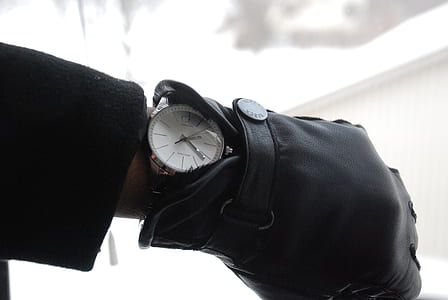 person wearing black leather glove and round black analog watch displaying 2:22 thumbnail