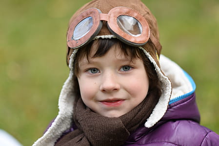 child smiling outdoor wearing aviator hat thumbnail