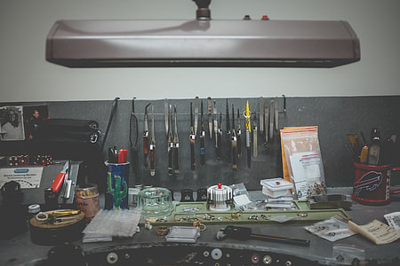 assorted-color-and-type hand tools on gray table thumbnail