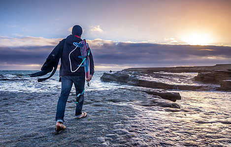 man walking on grey path thumbnail
