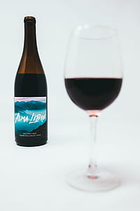 clear wine glass near Alma Libre wine bottle thumbnail
