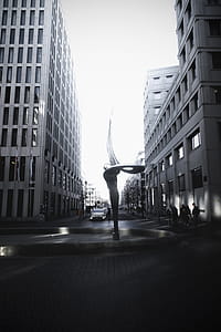 Spiral Shaped Fountain Statue Between Two High-rise Buildings thumbnail
