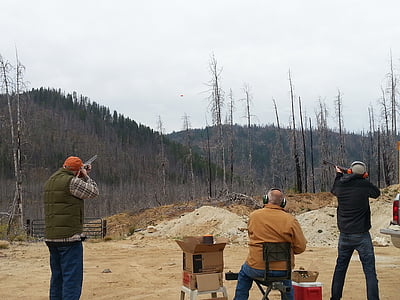 man holding hunting guns thumbnail