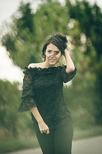 selective focus photo of woman holding her hair during daytime thumbnail