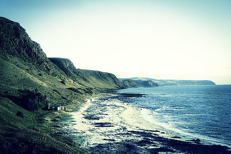 landscape photography of mountains and body of water thumbnail