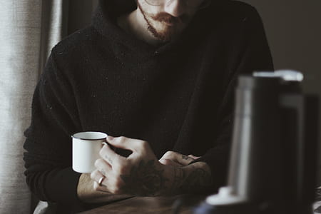 man holding mug while sitting thumbnail