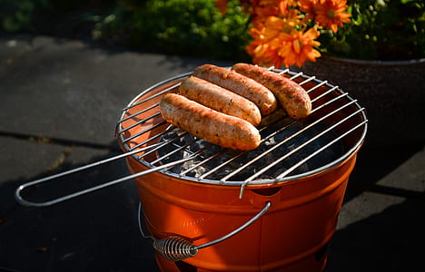 four sausages on orange grill thumbnail