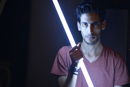 man holding lighted sword thumbnail
