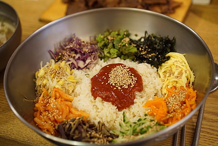 sliced of garlic, carrots, onions, and cooked rice with ketchup on gray bowl thumbnail