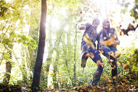 two man and woman in middle of forest during daytime thumbnail