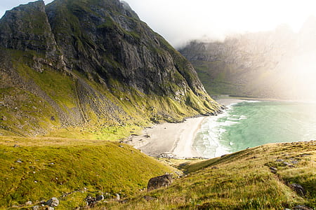 photography of green mountain near sea thumbnail