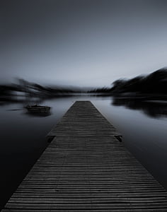 brown dock on body of water at night time thumbnail