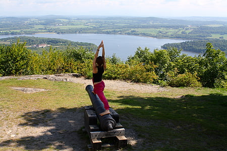 woman doing yoga post standing on cannon thumbnail