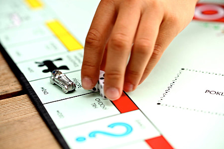 person playing monopoly holding fice thumbnail