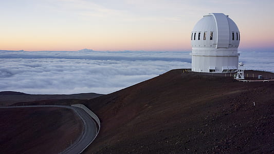 white dome building on peak of hill near sea of clouds thumbnail