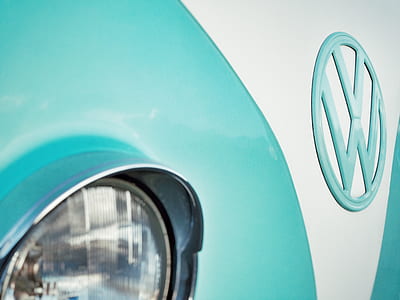 teal and white Volkswagen vehicle in closeup photography thumbnail