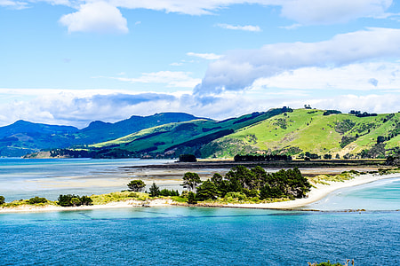 body of water near green land thumbnail