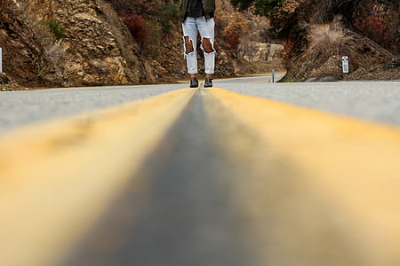 woman walking on asphalt road thumbnail
