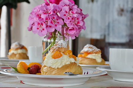 baked pastry with cream topping on top of plate thumbnail