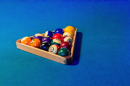billiard ball set on top of blue billiard table thumbnail