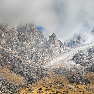 gray rock formations under cloudy sky thumbnail