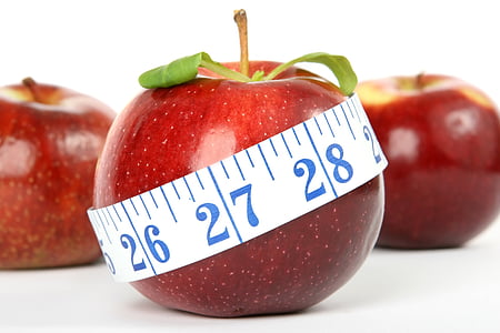 three red apples with one covered in white measuring tape thumbnail