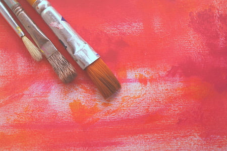 three assorted-size paintbrushes on red surface thumbnail