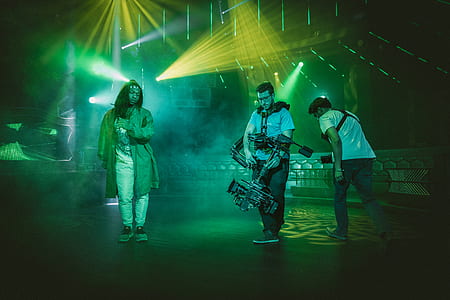 three person performing on stage with lights thumbnail