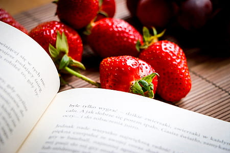several strawberries beside book thumbnail