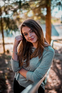 woman leaning on gray metal frame thumbnail