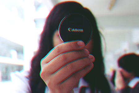 Girl Holding Black Canon Cover thumbnail