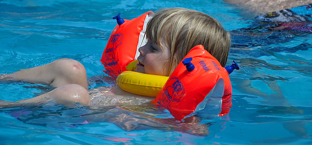 boy floating in swimming pool thumbnail