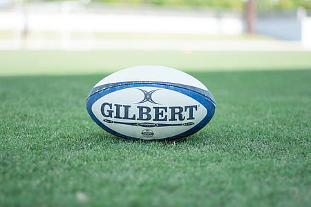 selective focus photography Gilbert pigskin ball on field thumbnail