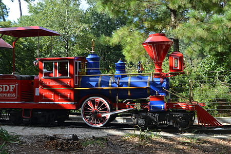red and blue train on train rails thumbnail