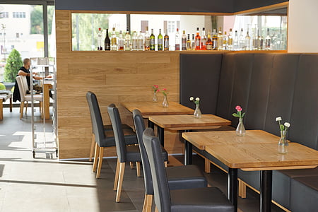 grey leather padded brown wooden base chairs beside square brown wooden tables thumbnail
