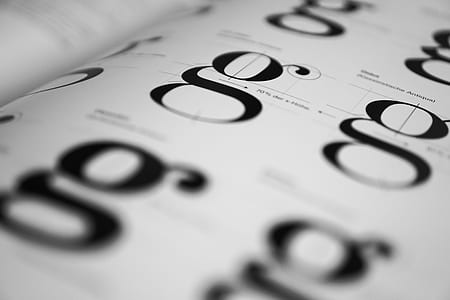 white and black g letter printed paper thumbnail