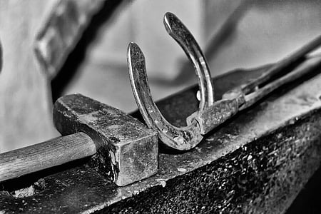selective focus photography of horseshoe and hammer thumbnail
