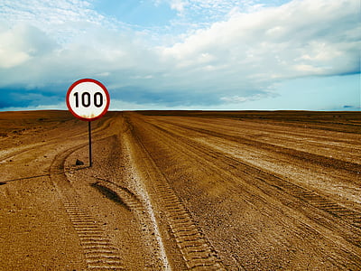 white and red 100 road signage during daytime thumbnail
